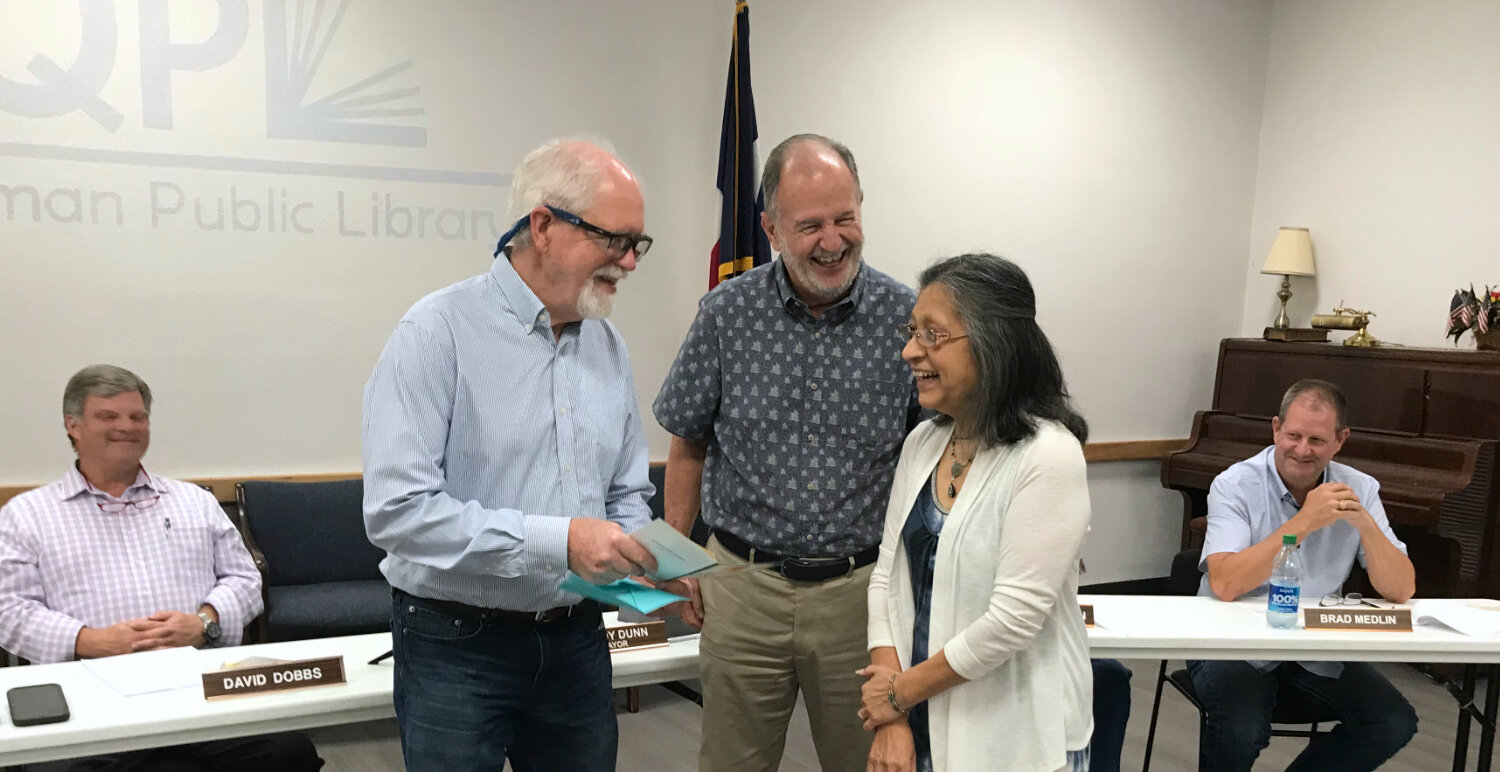 Kevin Taylor, left, and wife Josie share a laugh with Quitman Mayor Randy Dunn Thursday when Taylor was honored by the city council upon his retirement.